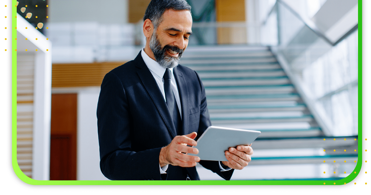 A man in an office looking at this tablet