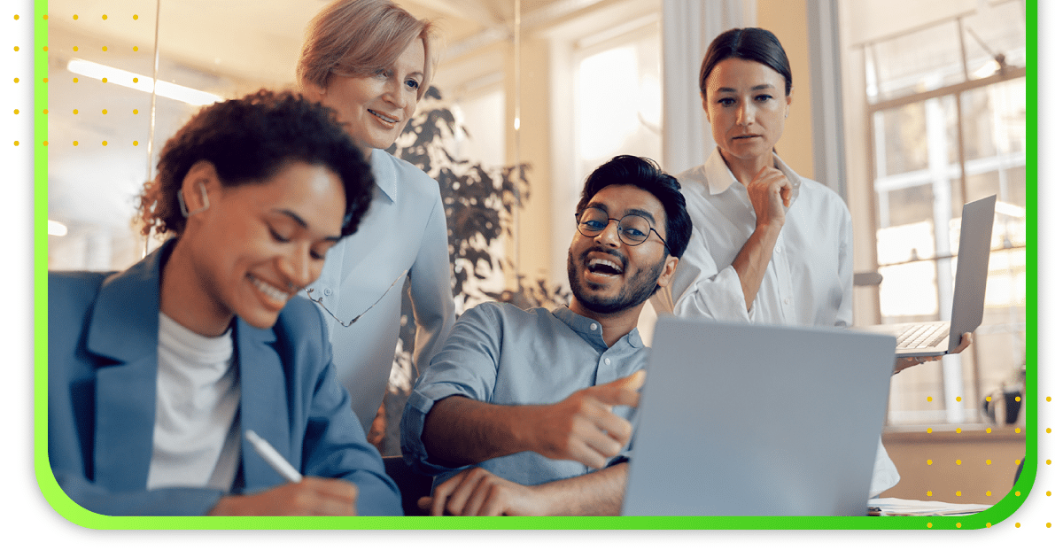 A group of people in the office looking at a computer