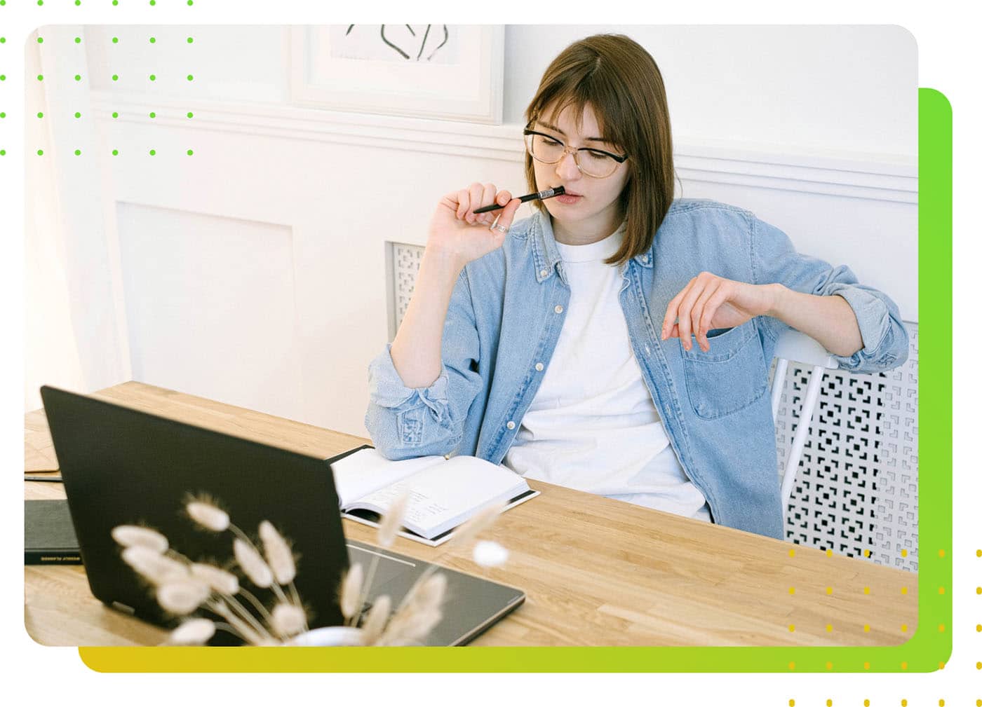 A female worker thinking in front of a laptop