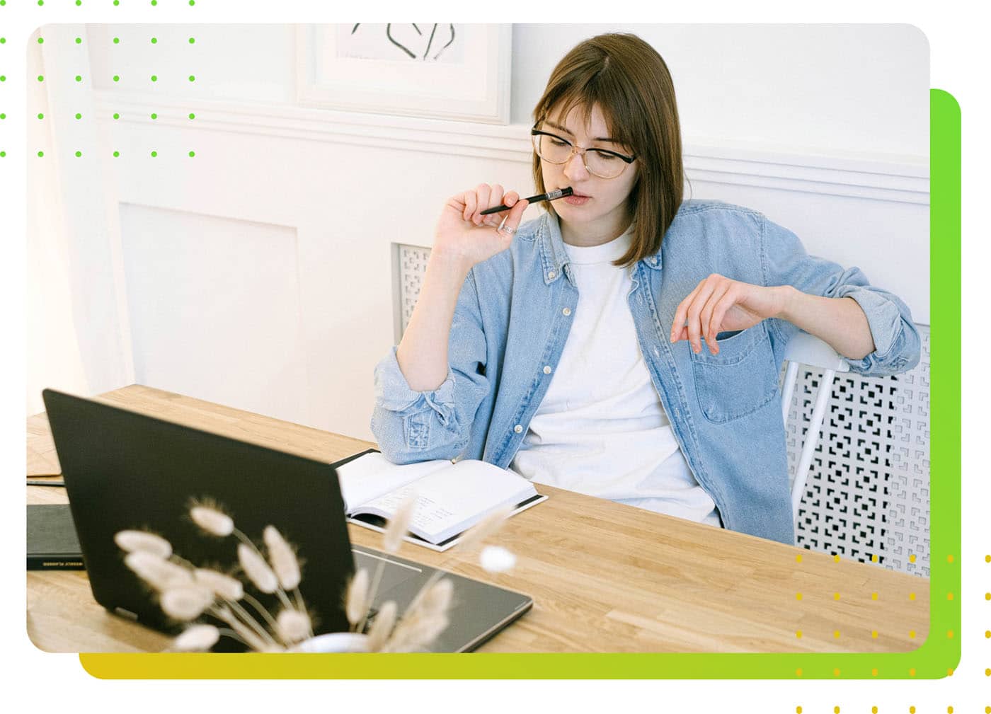 A female worker thinking in front of a laptop