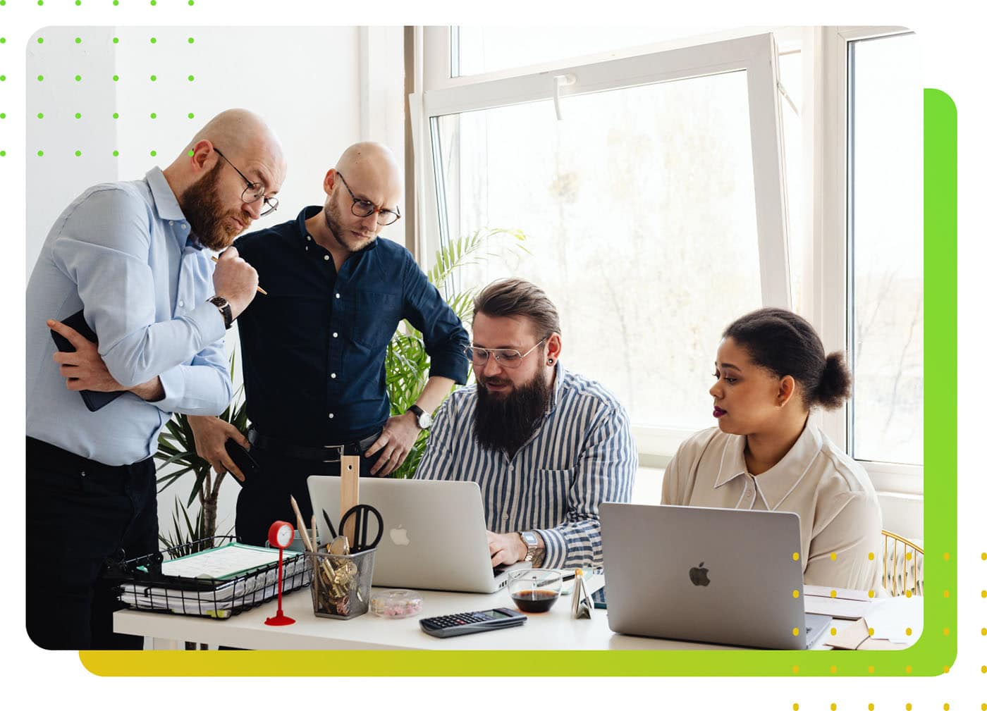 A group of people checking a laptop