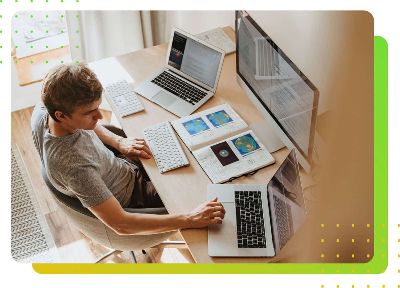 A man in front of three computer screens