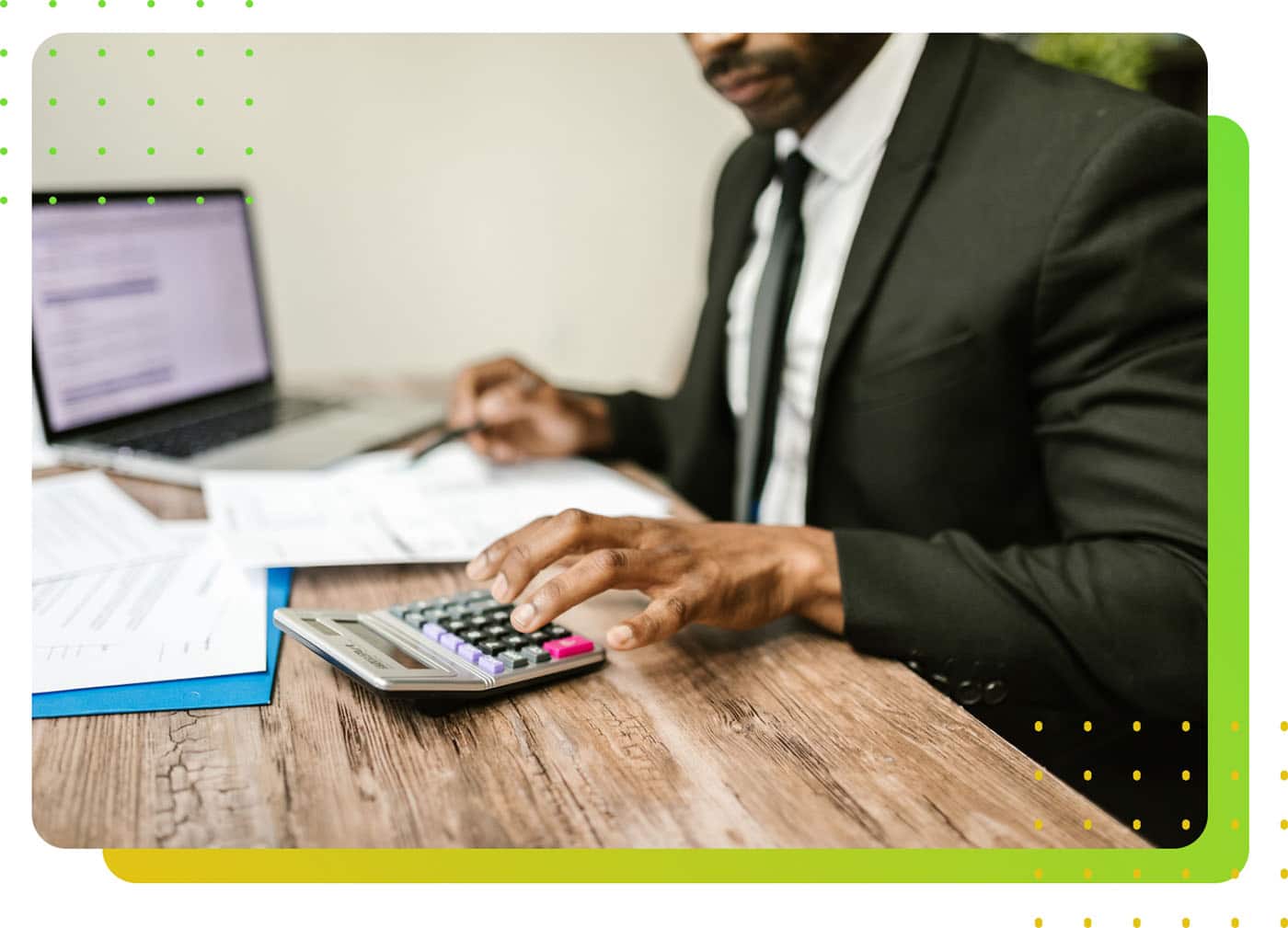 A man in suit pressing a calculator