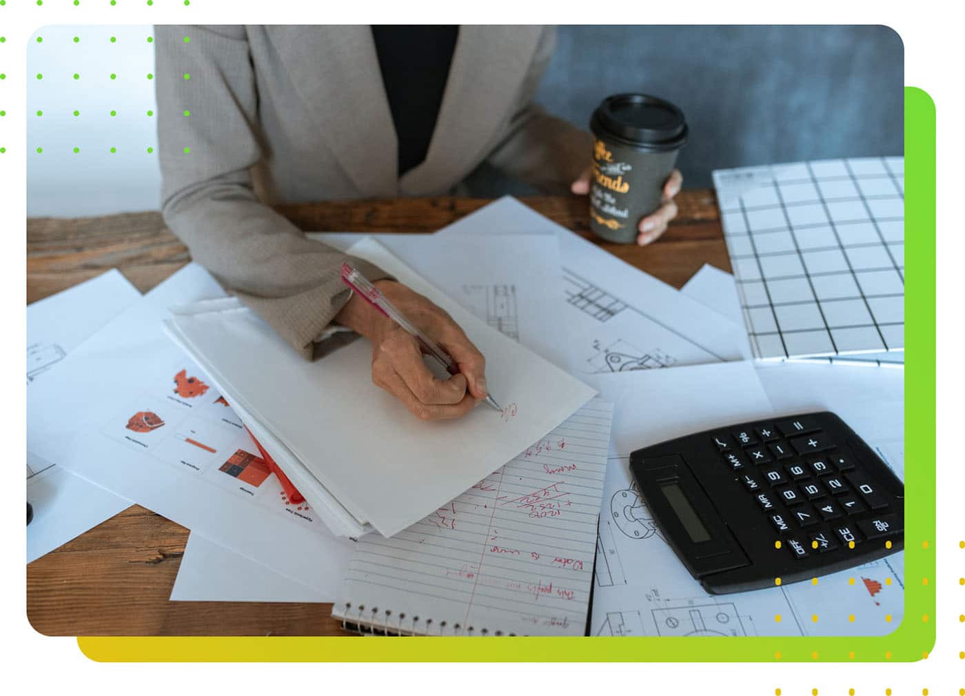 A person holding a pen, writing on a paper