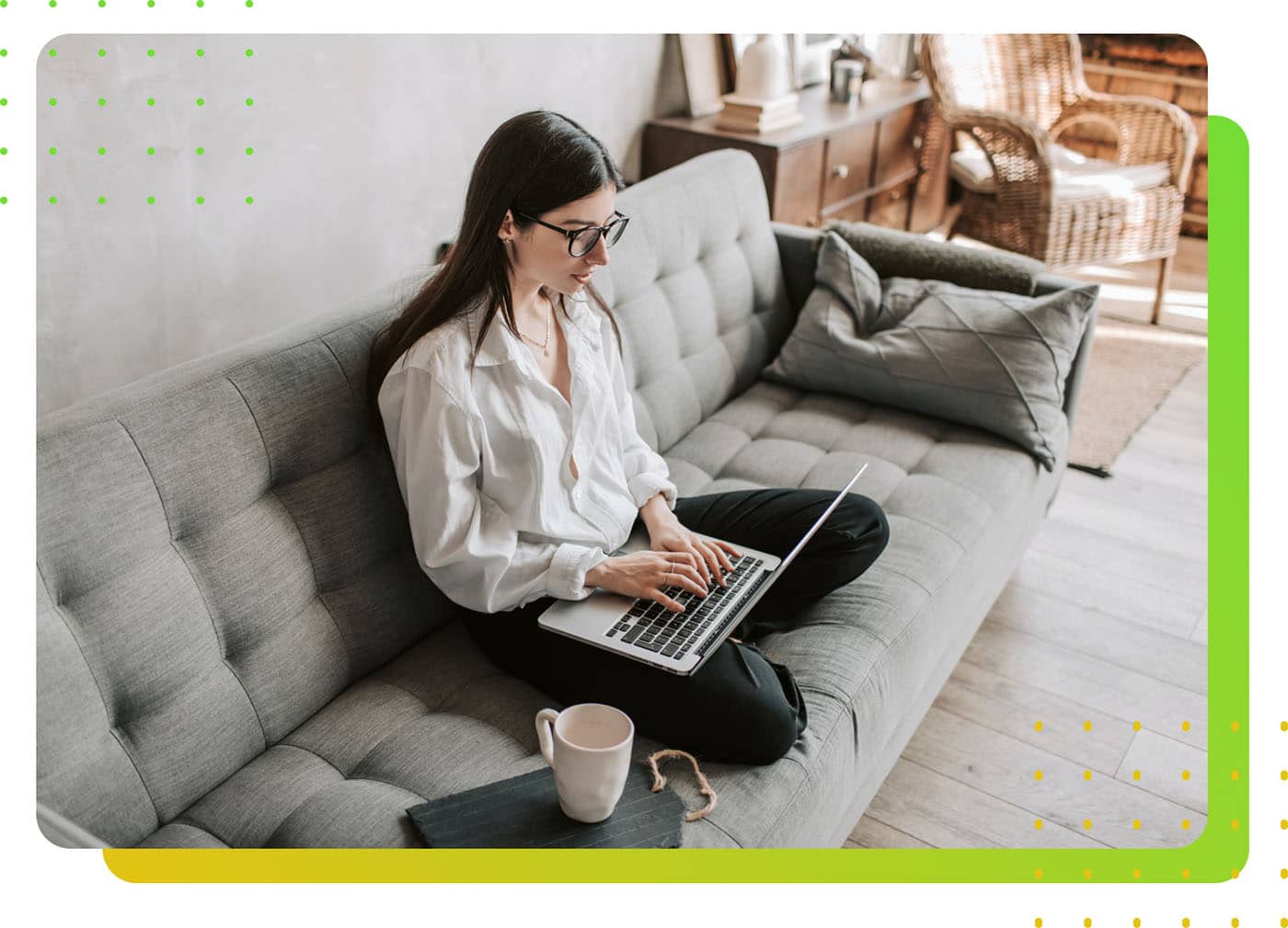 A woman pressing a laptop on a couch