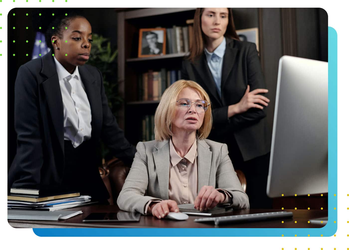 Three lawyers in front of a laptop