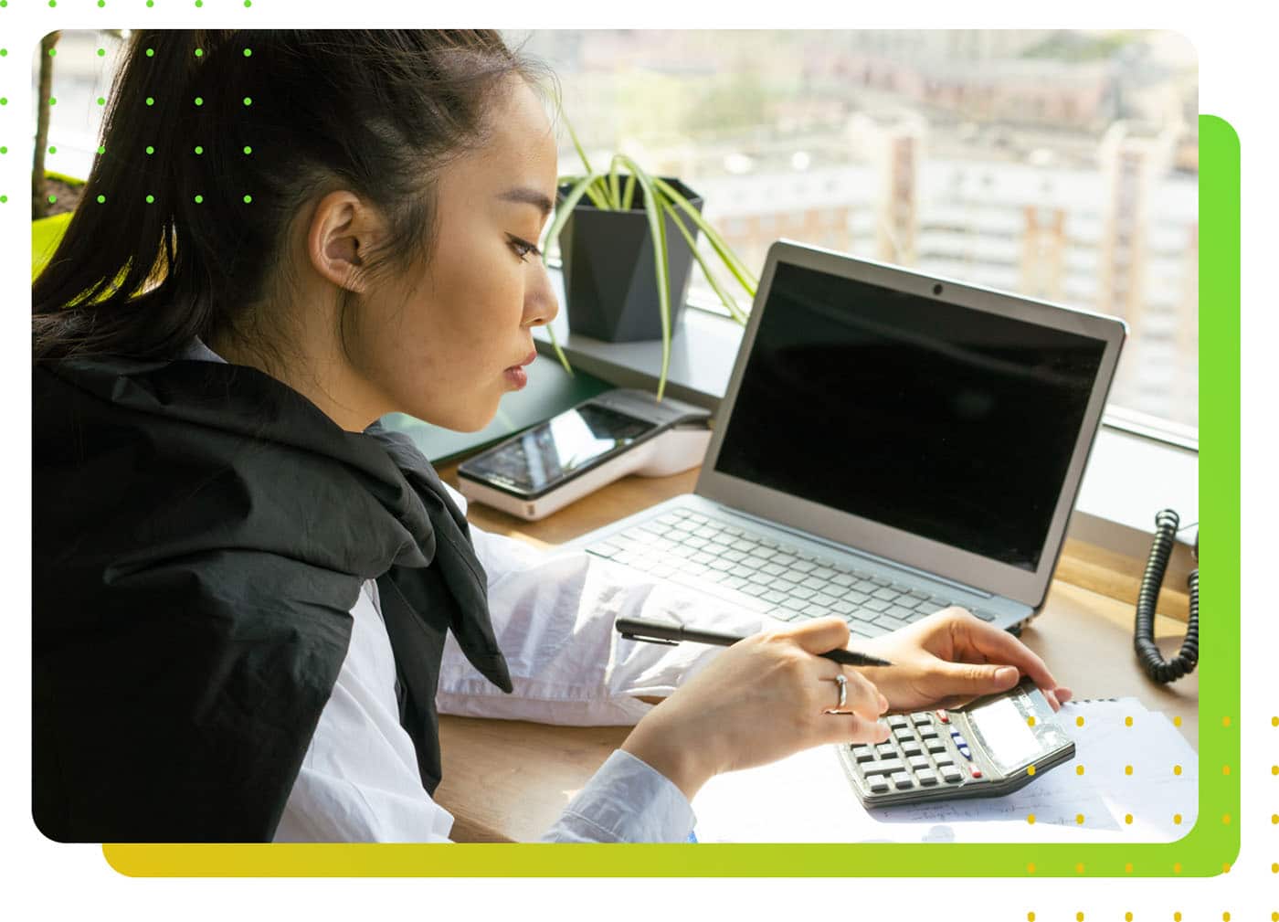 A woman wearing a white shirt using a calculator